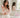 Femme vêtue d’une blouse rose pâle présentant un flacon de parfum dans une salle de bain claire et élégante.
